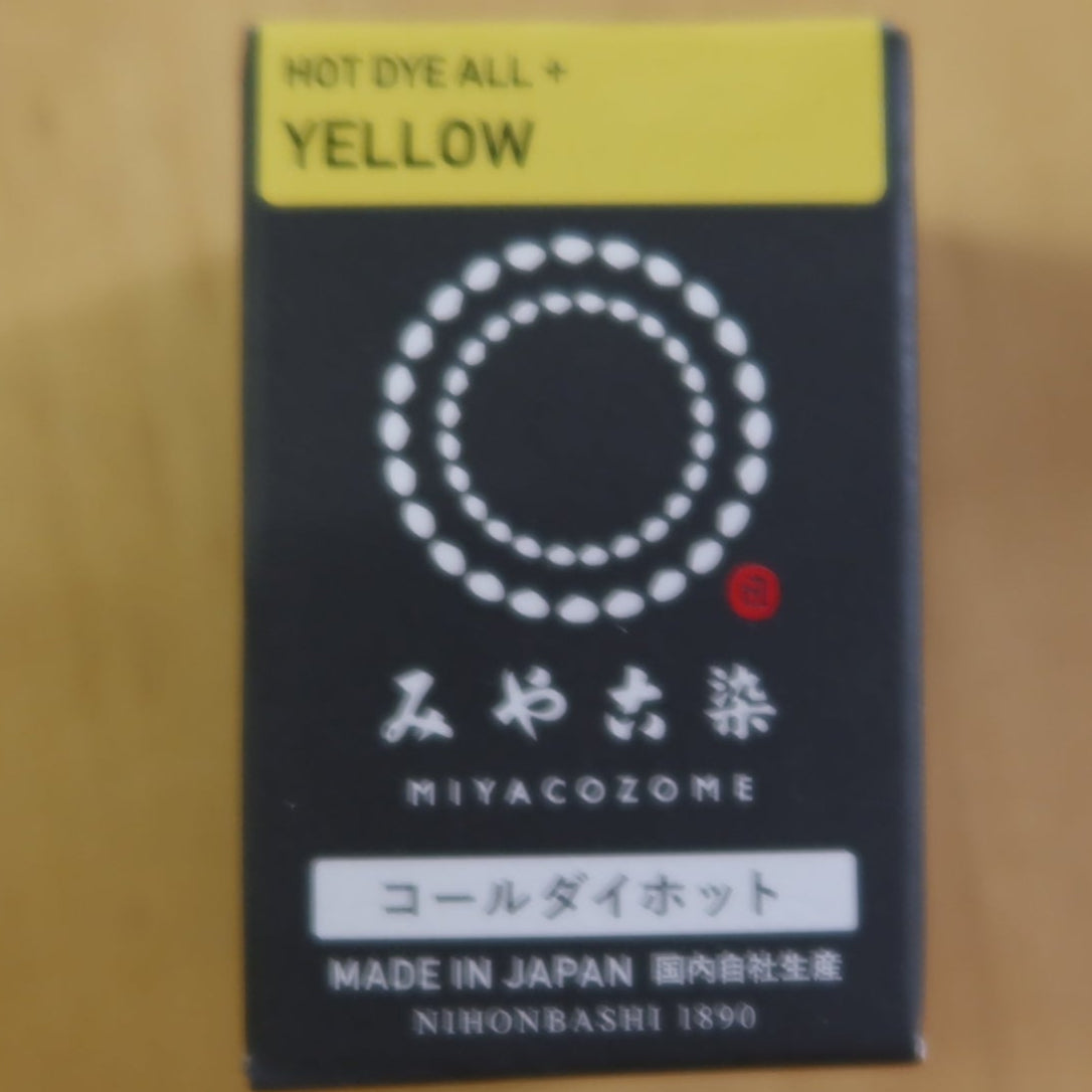 Box of Miyacome dye with yellow top on a wooden background