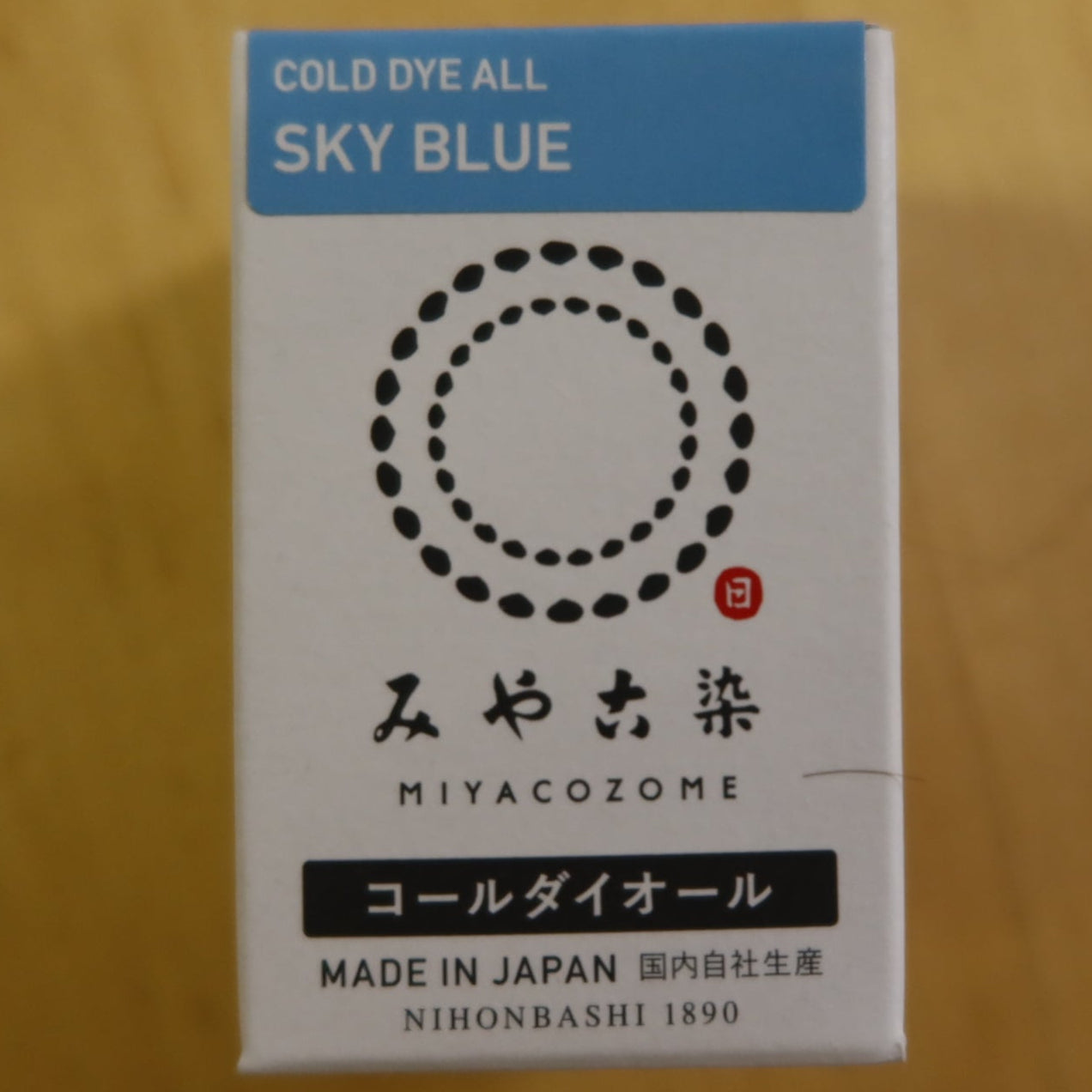 Box of Miyacozome cold dye in sky blue on a wooden surface